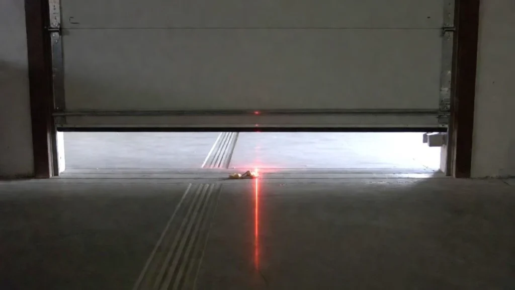 object blocking garage door sensor beam near floor