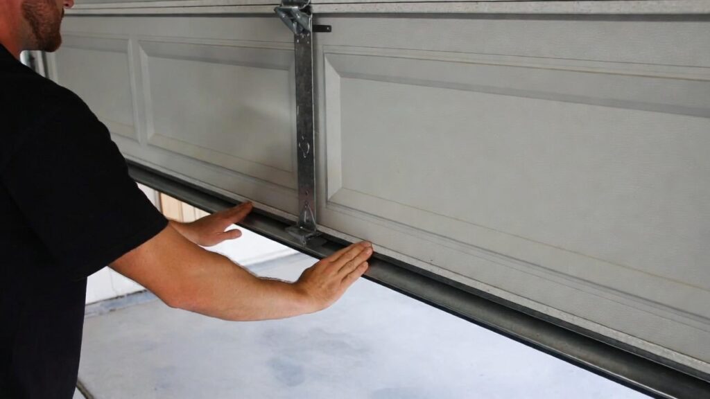 lifting garage door manually to test if door is heavy