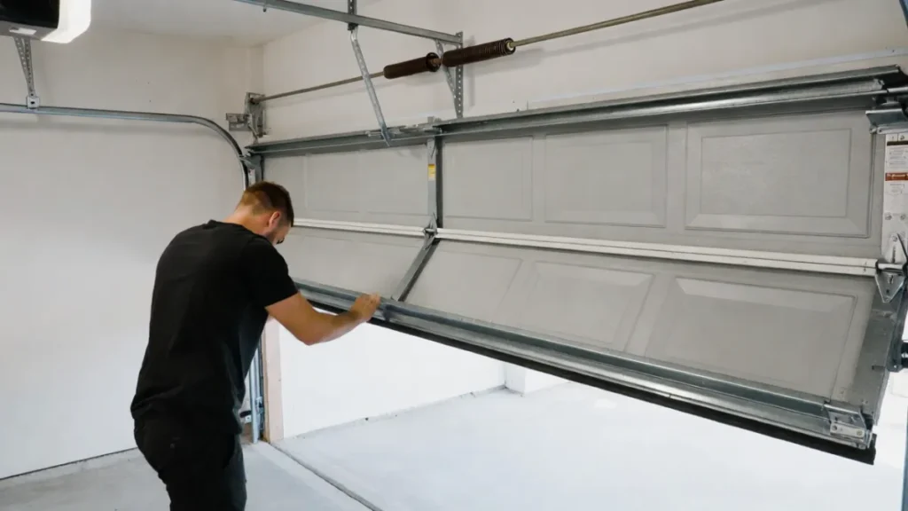 testing garage door by lifting manually to check if it is heavy
